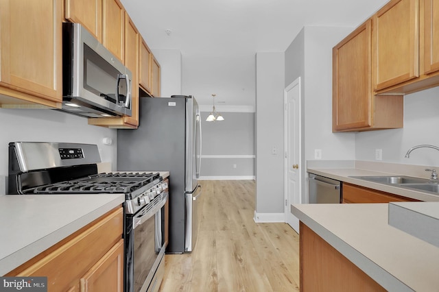 503 King Farm Blvd Unit 306, Rockville, MD 20850 - kitchen with stainless steel appliances, light wood-type flooring, light countertops, a sink, and a chandelier