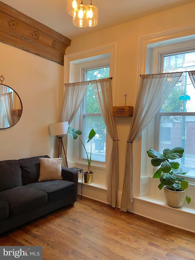 living room with a notable chandelier and wood finished floors
