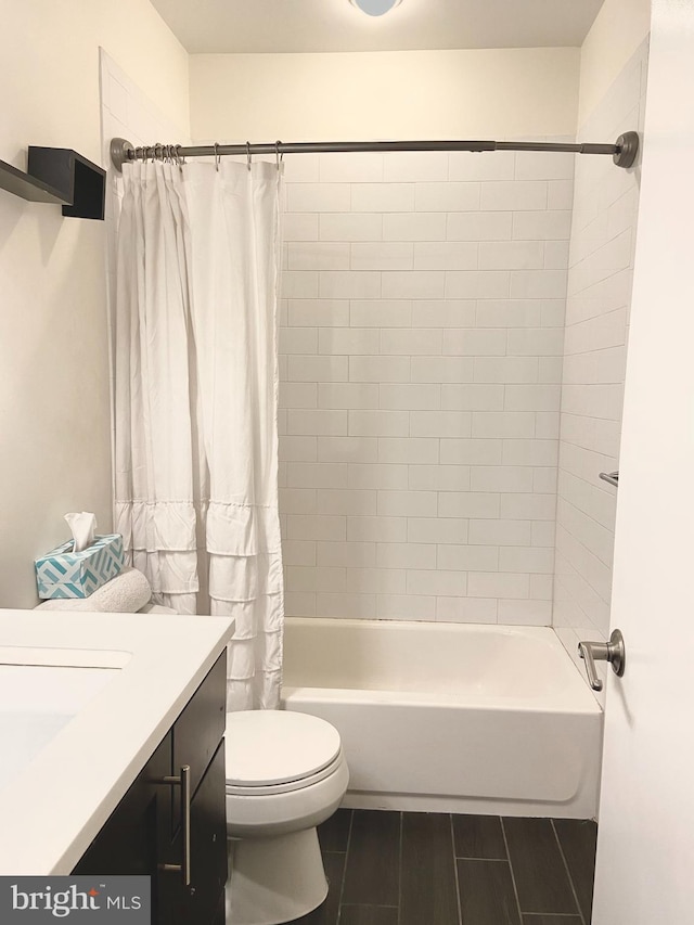 full bathroom featuring toilet, shower / bathtub combination with curtain, and vanity