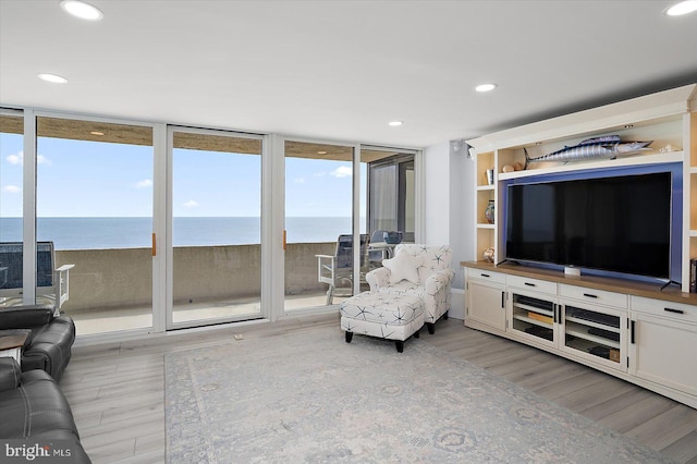 8500 Coastal Hwy Unit 805, Ocean City, MD 21842 - living area featuring light wood-style flooring, a wall of windows, and recessed lighting