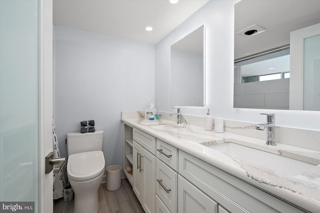 8500 Coastal Hwy Unit 805, Ocean City, MD 21842 - bathroom featuring double vanity, a sink, toilet, and wood finished floors