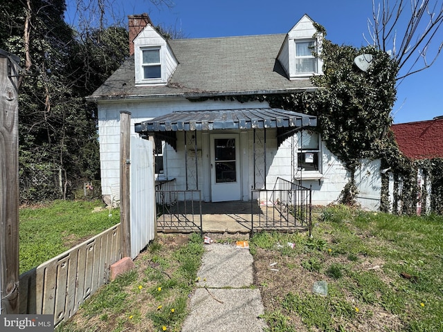 605 Walnut Ave, Baltimore, MD 21229 - view of front of property with covered porch, a chimney, and roof with shingles