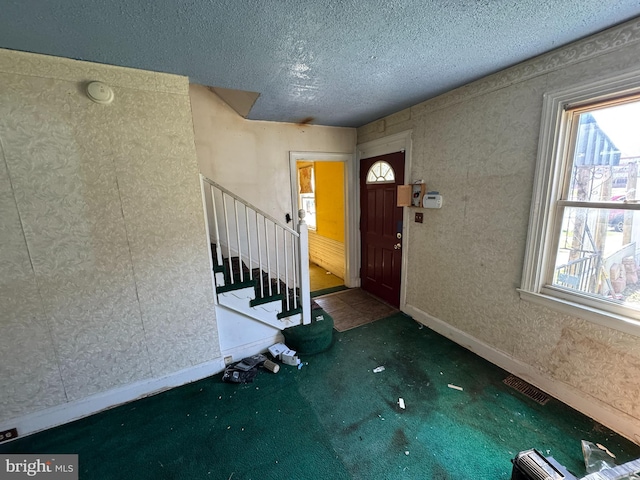 605 Walnut Ave, Baltimore, MD 21229 - entrance foyer with stairs, carpet flooring, baseboards, a textured ceiling, and visible vents