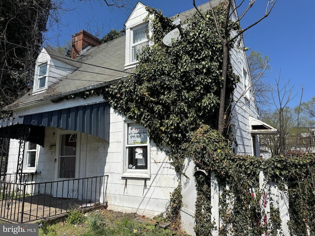 605 Walnut Ave, Baltimore, MD 21229 - view of side of home with a chimney