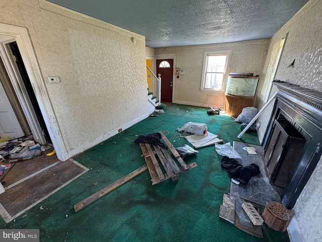 605 Walnut Ave, Baltimore, MD 21229 - unfurnished living room featuring stairs, a fireplace, carpet flooring, and a textured ceiling