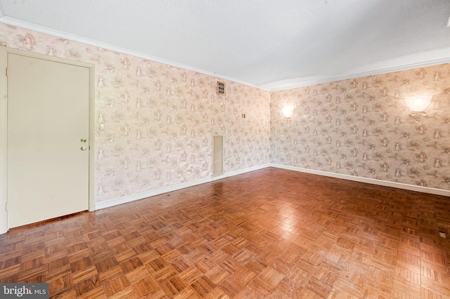 spare room with baseboards, ornamental molding, and wallpapered walls