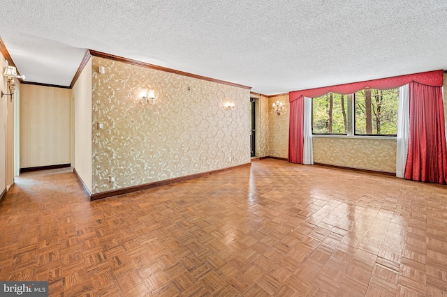 unfurnished living room with baseboards, ornamental molding, a textured ceiling, and wallpapered walls