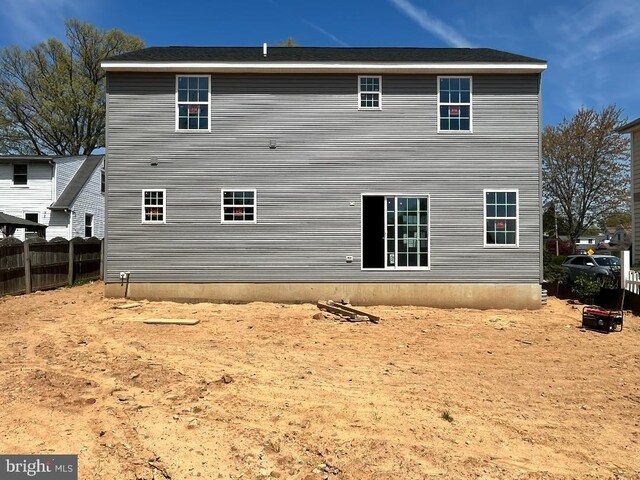 rear view of house with fence