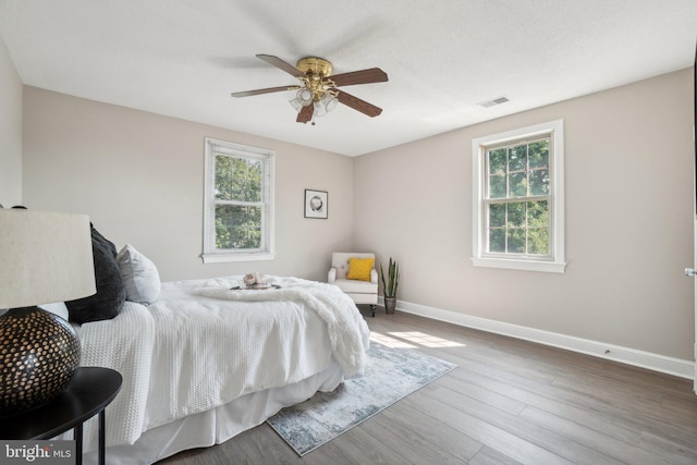 2507 Arlington Blvd Unit 20, Arlington, VA 22201 - bedroom featuring wood finished floors, baseboards, multiple windows, and visible vents
