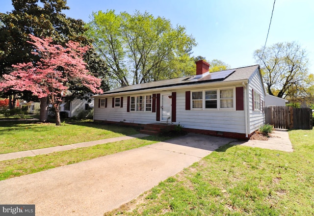 1405 Westchester St, Salisbury, MD 21801 - ranch-style house with a chimney, a front lawn, fence, and roof mounted solar panels