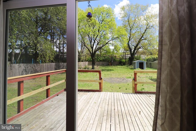 1405 Westchester St, Salisbury, MD 21801 - wooden deck with a fenced backyard, an outdoor structure, a yard, and a storage shed