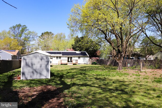 1405 Westchester St, Salisbury, MD 21801 - back of house with a yard, a fenced backyard, an outdoor structure, and a storage unit