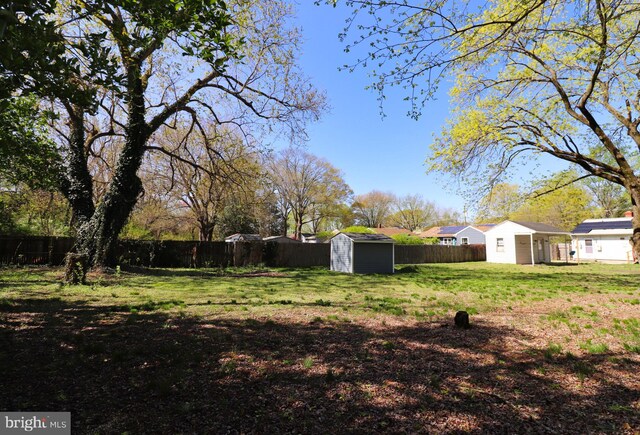 1405 Westchester St, Salisbury, MD 21801 - view of yard featuring a storage shed, a fenced backyard, and an outdoor structure