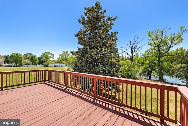 wooden deck featuring a yard