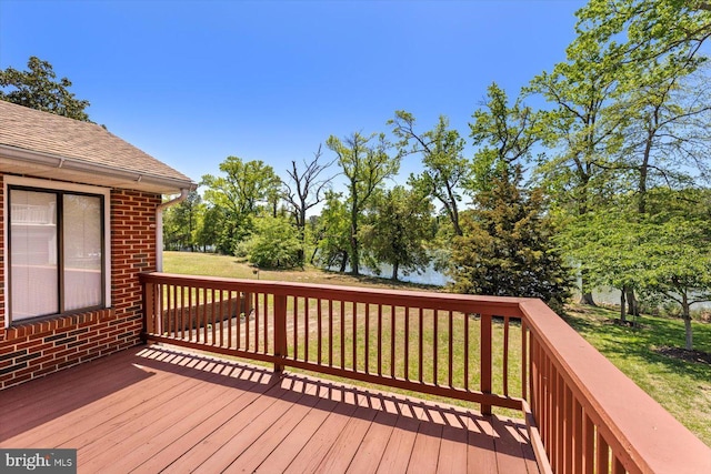 wooden deck featuring a yard