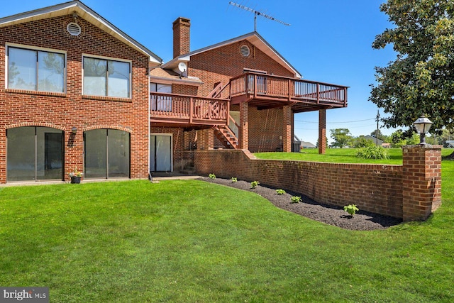 back of house with a deck, brick siding, a lawn, and a chimney
