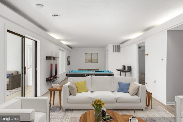 living room with billiards, light wood-type flooring, and baseboards