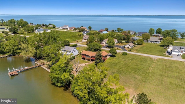 aerial perspective of suburban area with a nearby body of water