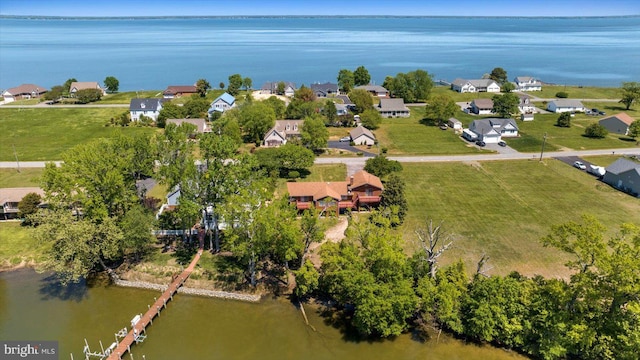 aerial view of property's location featuring a large body of water and nearby suburban area