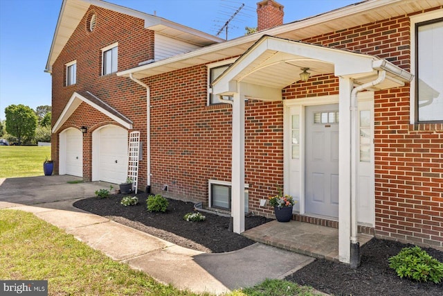 view of front of property with brick siding, asphalt driveway, and a chimney