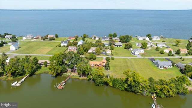 aerial view of residential area featuring a large body of water