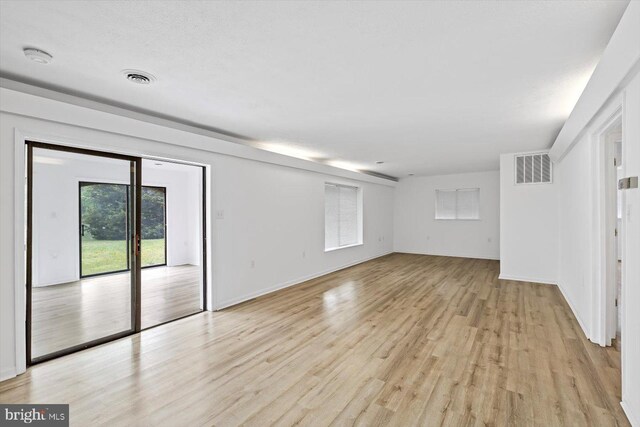 unfurnished living room featuring light wood-style flooring and baseboards