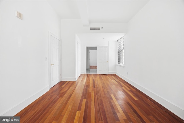 1500 Chestnut St Unit 15H, Philadelphia, PA 19102 - unfurnished bedroom with visible vents, hardwood / wood-style flooring, baseboards, and beam ceiling