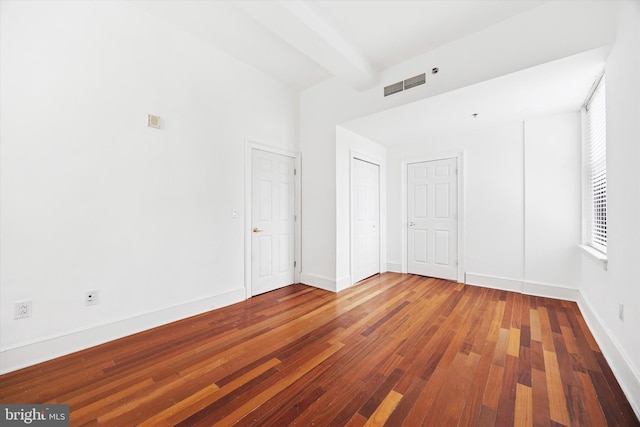 1500 Chestnut St Unit 15H, Philadelphia, PA 19102 - unfurnished room with visible vents, baseboards, hardwood / wood-style flooring, and beamed ceiling