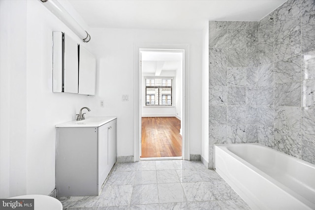 1500 Chestnut St Unit 15H, Philadelphia, PA 19102 - full bathroom featuring marble finish floor, vanity, baseboards, and a washtub