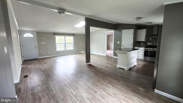 interior space featuring baseboards, a textured ceiling, dark wood-style floors, and visible vents
