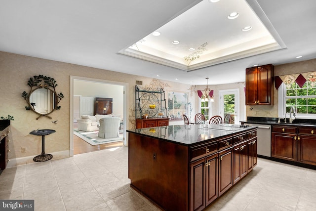 kitchen featuring a sink, black electric cooktop, plenty of natural light, and dishwasher