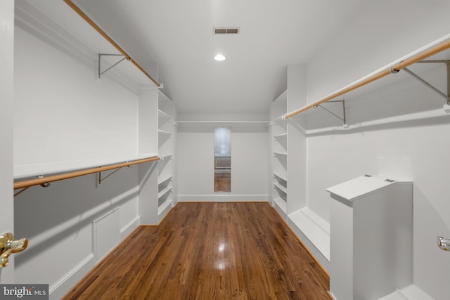 walk in closet featuring wood finished floors and visible vents