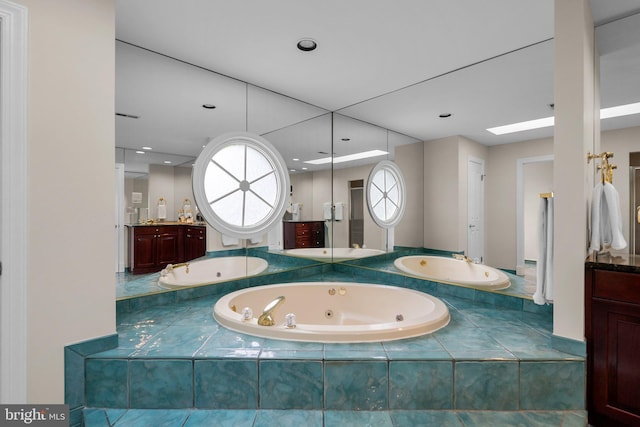 bathroom featuring a jetted tub and vanity