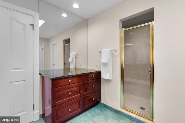 bathroom featuring vanity, recessed lighting, a stall shower, and tile patterned flooring
