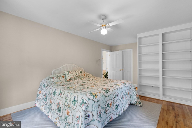 bedroom featuring baseboards, a ceiling fan, and wood finished floors