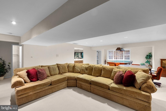 living area with recessed lighting and light colored carpet