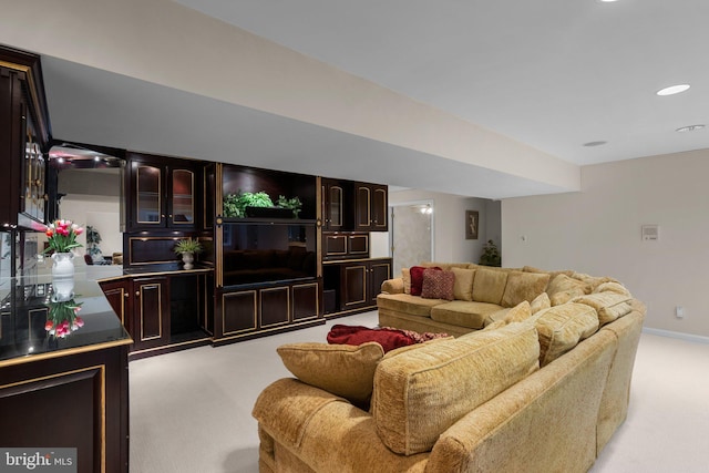 living area with light colored carpet and recessed lighting