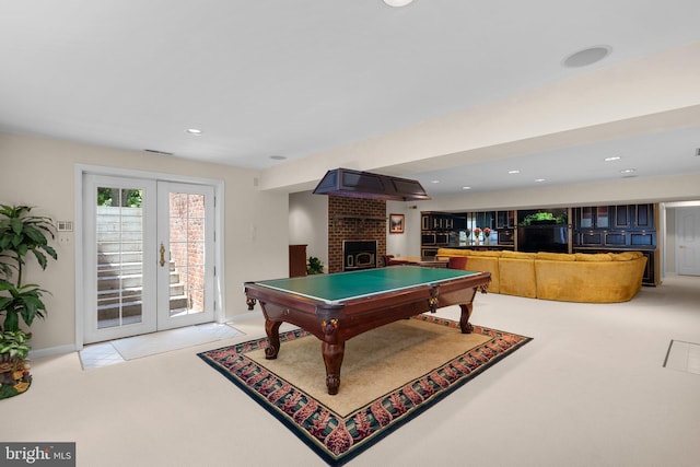 game room with billiards, french doors, visible vents, light colored carpet, and a brick fireplace