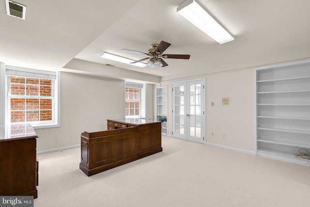 office featuring baseboards, a ceiling fan, french doors, and light colored carpet
