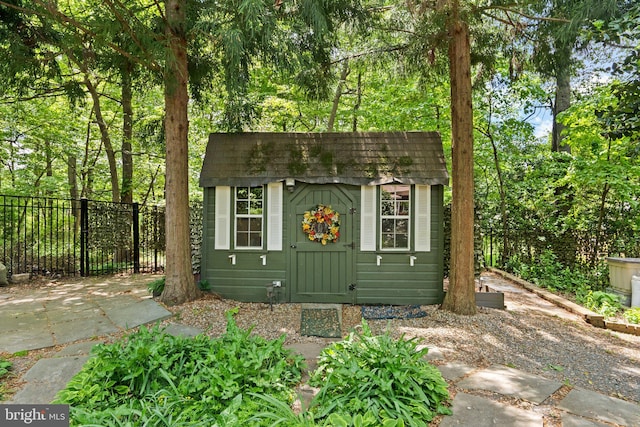 view of shed featuring fence