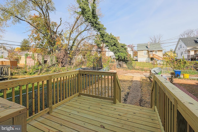 wooden terrace featuring a residential view and fence