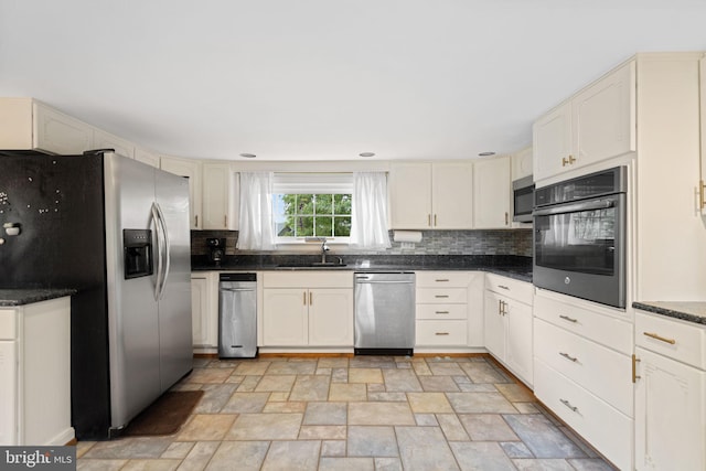 669 Dicks Hollow Rd, Winchester, VA 22603 - kitchen featuring stainless steel appliances, a sink, stone finish floors, backsplash, and cream cabinets