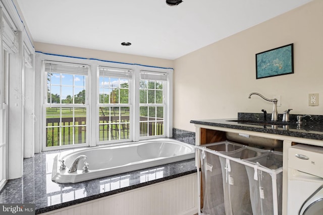 669 Dicks Hollow Rd, Winchester, VA 22603 - full bath with washer / clothes dryer, a garden tub, and a sink