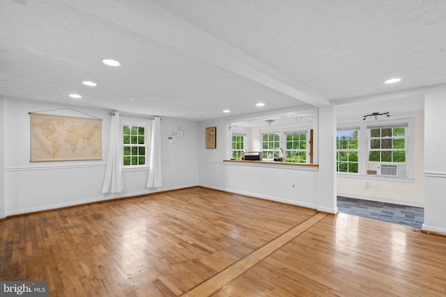 669 Dicks Hollow Rd, Winchester, VA 22603 - unfurnished living room with a textured ceiling, wood-type flooring, recessed lighting, baseboards, and healthy amount of natural light