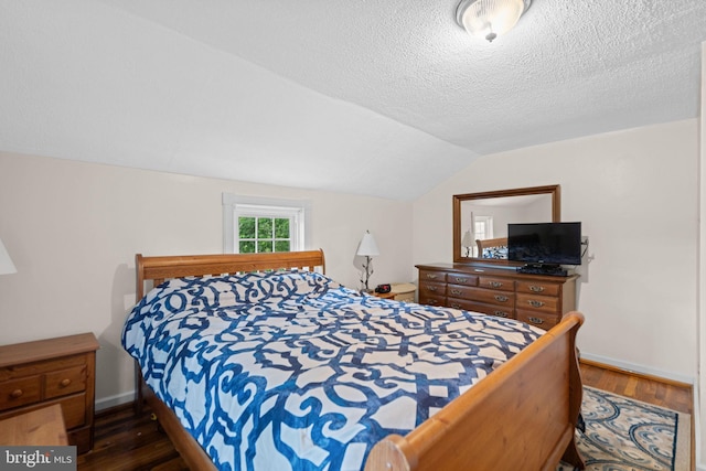 669 Dicks Hollow Rd, Winchester, VA 22603 - bedroom featuring lofted ceiling, wood finished floors, a textured ceiling, and baseboards