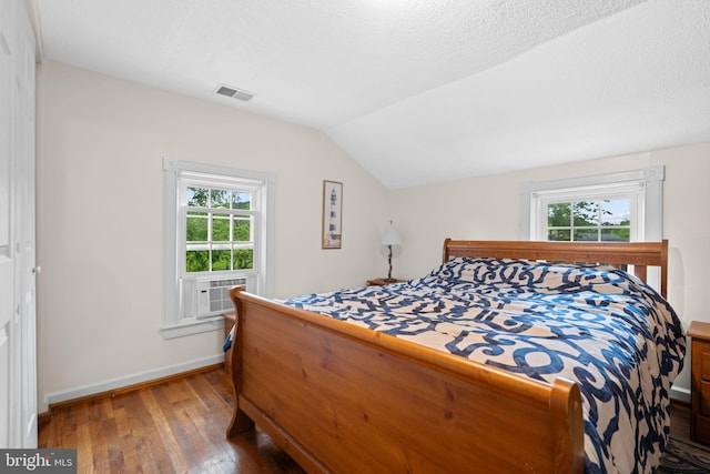 669 Dicks Hollow Rd, Winchester, VA 22603 - bedroom featuring hardwood / wood-style flooring, lofted ceiling, multiple windows, baseboards, and cooling unit