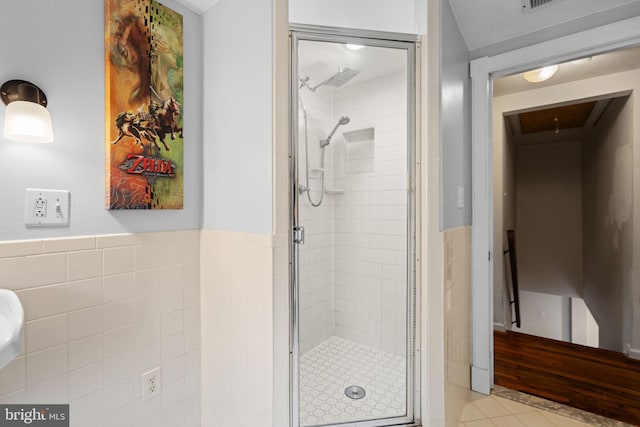 669 Dicks Hollow Rd, Winchester, VA 22603 - bathroom with a shower stall, tile patterned floors, tile walls, and a wainscoted wall