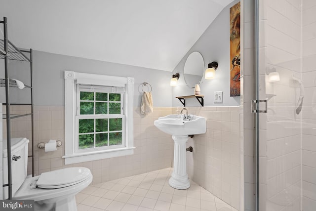 669 Dicks Hollow Rd, Winchester, VA 22603 - bathroom with tile walls, toilet, a stall shower, tile patterned floors, and a wainscoted wall