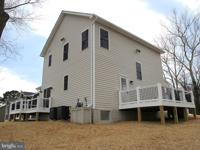 back of house with central AC and a deck