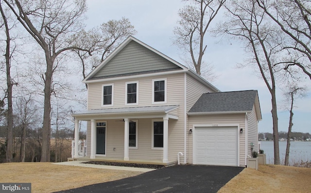 view of front of house featuring covered porch, driveway, a garage, and roof with shingles